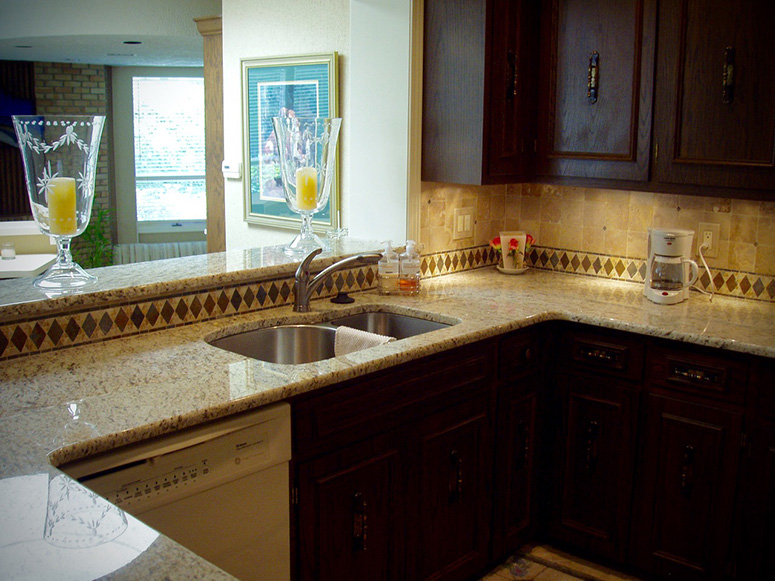 Photo: U-shaped kitchen featuring new countertops in an open plan setting.