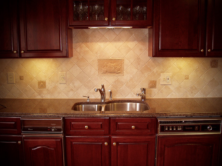 Photo: A kitchen counter with built-in sink and granite countertop.